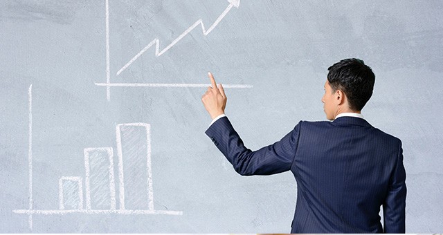 グラフを指し示す男性
