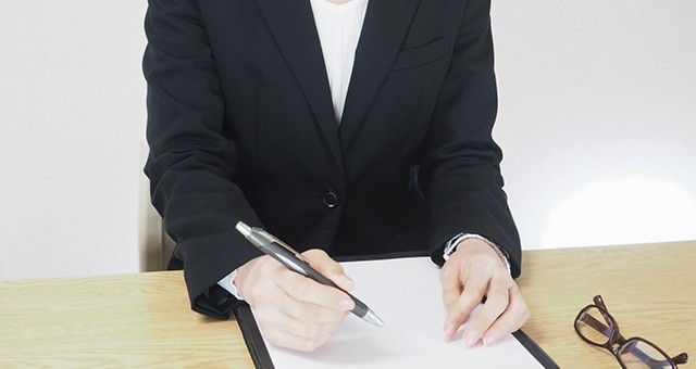 エントリーシートに記入中の女性